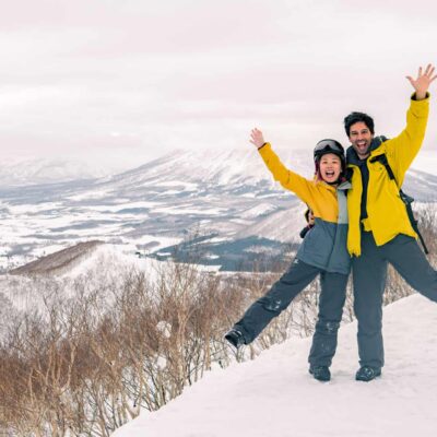 Couple waiving in ski resort in Japan, Rusutsu